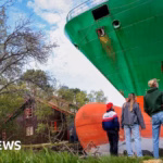 Norwegian Resident awakens to Discover Massive Shipping Vessel in Backyard