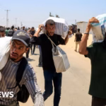 Palestinian reports claim that both local armed individuals and Israeli troops were involved in a shooting incident in close proximity to a Gaza assistance location.