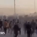 Footage captures large group of Palestinians scaling barrier and rapidly converging to assist at incident location.