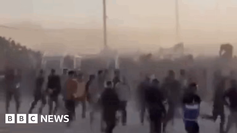 Footage captures large group of Palestinians scaling barrier and rapidly converging to assist at incident location.