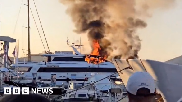 Fire engulfs opulent yacht in St Tropez, spewing thick smoke.