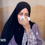 In the wake of an Israeli airstrike, a mother grieves for her sons and awaits humanitarian support.