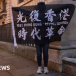 The UK criticizes Hong Kong for offering financial incentives in aiding the capture of activists.